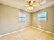 Bedroom featuring tiled flooring and two windows providing ample natural light at 3902 W Iowa Ave, Tampa, FL 33616