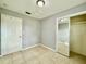 Bedroom featuring tiled flooring, closet, and a door at 3902 W Iowa Ave, Tampa, FL 33616