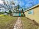 Exterior shot of charming home with stone pathway leading to the front door at 3902 W Iowa Ave, Tampa, FL 33616