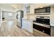 Renovated kitchen features stainless steel appliances and is open to the living room at 3902 W Iowa Ave, Tampa, FL 33616