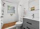 Updated bathroom featuring white subway tile, wooden shower floor, and stylish gray vanity at 4921 24Th S Ave, Gulfport, FL 33707