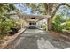 Charming blue house with a covered carport, outdoor seating, and lush greenery surrounding the property at 4921 24Th S Ave, Gulfport, FL 33707