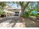 Charming blue house with a covered carport, outdoor seating, and lush greenery surrounding the property at 4921 24Th S Ave, Gulfport, FL 33707