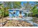 Charming blue house with a walkway leading to the front door, accented by awnings and a seating area at 4921 24Th S Ave, Gulfport, FL 33707