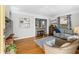 Cozy living room with hardwood floors, a gray sofa, and a view of the kitchen at 4921 24Th S Ave, Gulfport, FL 33707