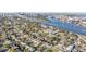 An aerial view showcases the neighborhood, a waterway, and a cityscape in the distance on a sunny day at 619 Danube Ave, Tampa, FL 33606