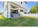 Backyard featuring concrete stairs leading to the covered patio and a freshly cut lawn at 619 Danube Ave, Tampa, FL 33606