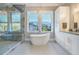 Elegant bathroom with a freestanding tub, walk-in shower, and stylish white cabinetry at 619 Danube Ave, Tampa, FL 33606