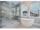 Beautiful bathroom featuring a glass-enclosed shower, modern bathtub, and elegant gray tile work at 619 Danube Ave, Tampa, FL 33606