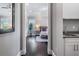 Inviting bedroom entrance with wood floors, a plant near a window and a glimpse of a bathroom sink at 619 Danube Ave, Tampa, FL 33606