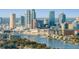 A detailed view shows the city skyline along a riverfront, with boats and buildings in clear focus at 619 Danube Ave, Tampa, FL 33606