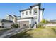 Home exterior featuring a gray brick driveway, a large garage and a manicured lawn at 619 Danube Ave, Tampa, FL 33606