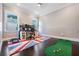 Bright office featuring hardwood floors, two windows, a large desk, and a unique British flag patterned rug at 619 Danube Ave, Tampa, FL 33606