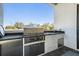 Outdoor kitchen featuring stainless steel grill, sink, countertop and cabinet space at 619 Danube Ave, Tampa, FL 33606