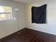 This bedroom features a dark floor, a torchiere lamp, and a window at 6347 S Lansdale Cir, Tampa, FL 33616