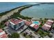 Aerial view of Isla del Sol condo with community pool, dock, Tampa Bay, and parking at 6365 Bahia Del Mar Blvd # 112, St Petersburg, FL 33715