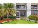 Exterior of property with access to screened in lanai, beautiful landscaping and flowering plants at 6365 Bahia Del Mar Blvd # 112, St Petersburg, FL 33715