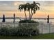 Picturesque waterfront view with palm trees, white picket fence and lounge chairs overlooking boats docked at the marina at 6365 Bahia Del Mar Blvd # 112, St Petersburg, FL 33715