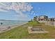 Beautiful water view with a bench in front of a condominium complex on a sunny day at 6365 Bahia Del Mar Blvd # 112, St Petersburg, FL 33715