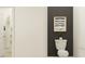 Stylish powder room with a modern toilet, elegant artwork, and convenient storage solutions at 6866 E 115Th St, Palmetto, FL 34221