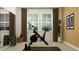 Bright exercise room featuring a stationary bike, dumbbells, and ample natural light from the large windows at 6866 E 115Th St, Palmetto, FL 34221