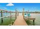 Private boat dock with a boat lift and seating on the canal at 7984 1St S Ave, St Petersburg, FL 33707