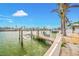 A private wooden dock equipped with a boat lift on a canal at 7984 1St S Ave, St Petersburg, FL 33707