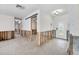 Spacious living room showing exposed framework ready for renovation, featuring a decorative glass front door at 7984 1St S Ave, St Petersburg, FL 33707