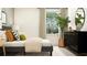 Modern bedroom featuring neutral decor, white rug, large window and dark wood dresser at 8529 Bella Mar Trl, Parrish, FL 34219