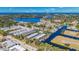 Aerial view of waterfront community featuring townhomes, canals, and lake access at 876 Callista Cay Loop, Tarpon Springs, FL 34689