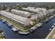 Aerial view showcasing the waterfront townhomes with boat docks and lush green landscaping at 876 Callista Cay Loop, Tarpon Springs, FL 34689