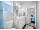 Bright bathroom featuring a white vanity, modern fixtures, and a doorway to a bedroom at 876 Callista Cay Loop, Tarpon Springs, FL 34689