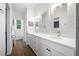 Spacious bathroom featuring double vanity, decorative mirrors, and elegant lighting fixtures at 876 Callista Cay Loop, Tarpon Springs, FL 34689