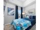 Cozy bedroom with a comfy bed, stylish decor, and ample natural light from the window at 876 Callista Cay Loop, Tarpon Springs, FL 34689