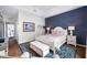 Warm bedroom featuring a tray ceiling, blue accent wall, and custom built-in storage at 876 Callista Cay Loop, Tarpon Springs, FL 34689
