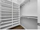 Walk-in closet with custom shelving and plenty of hanging space for organized storage at 876 Callista Cay Loop, Tarpon Springs, FL 34689