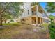 Backyard of a three-story home with a covered patio on the ground floor at 876 Callista Cay Loop, Tarpon Springs, FL 34689