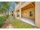 Covered patio on the ground floor of a three-story home with backyard at 876 Callista Cay Loop, Tarpon Springs, FL 34689
