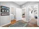 Functional hallway area with a laundry closet, access to an office, and modern interior decor at 876 Callista Cay Loop, Tarpon Springs, FL 34689