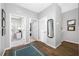 Inviting hallway with wood floors, neutral walls, and access to bedroom and office space at 876 Callista Cay Loop, Tarpon Springs, FL 34689