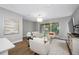 Bright living room features contemporary decor, stylish furnishings, and a sliding glass door leading to the balcony at 876 Callista Cay Loop, Tarpon Springs, FL 34689