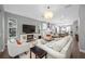 This stylish living room offers a comfortable seating area with open access to the kitchen, perfect for modern living at 876 Callista Cay Loop, Tarpon Springs, FL 34689