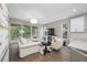Open-concept living space featuring comfortable seating, a decorative chandelier, and access to a balcony at 876 Callista Cay Loop, Tarpon Springs, FL 34689