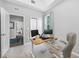 Versatile home office space featuring a sit/stand desk and views into the hallway and living room at 876 Callista Cay Loop, Tarpon Springs, FL 34689