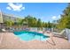 Community swimming pool area with lounge chairs and a white fence surrounding it at 876 Callista Cay Loop, Tarpon Springs, FL 34689