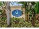Community sign for Callista Cay surrounded by lush greenery at 876 Callista Cay Loop, Tarpon Springs, FL 34689