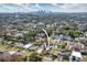 Aerial view of property with a clear property boundary, lush greenery, and views of the city skyline at 902 W Fribley St, Tampa, FL 33603