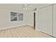 Bedroom featuring wood-look flooring, a window, and a closet at 9111 Sterling Ln, Port Richey, FL 34668