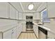 Well-lit kitchen with white cabinets, stainless steel appliances, and a clean, streamlined design at 9111 Sterling Ln, Port Richey, FL 34668