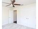 Bedroom featuring neutral walls, light carpet, ceiling fan, and a double door closet at 9705 Bay Grove Ln, Tampa, FL 33615